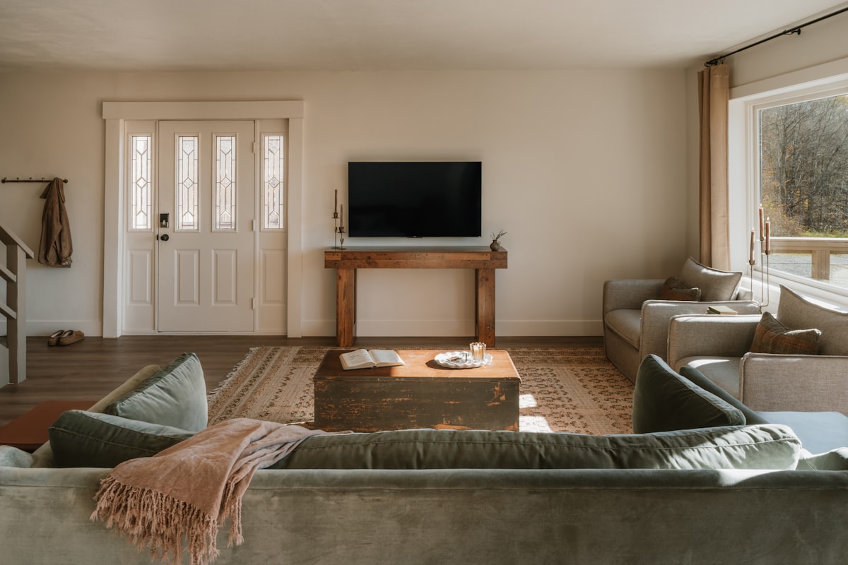 Modern 4K smart TV mounted on a living room wall showing a streaming interface